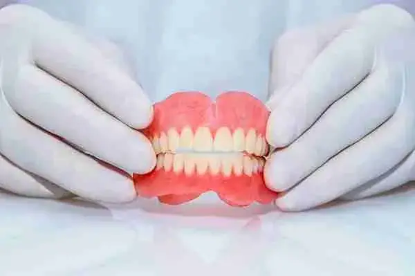resetsmile reviews reddit about a person holding a fake denture